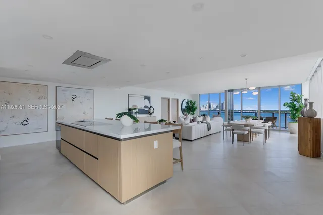 a view of a livingroom with furniture and a kitchen