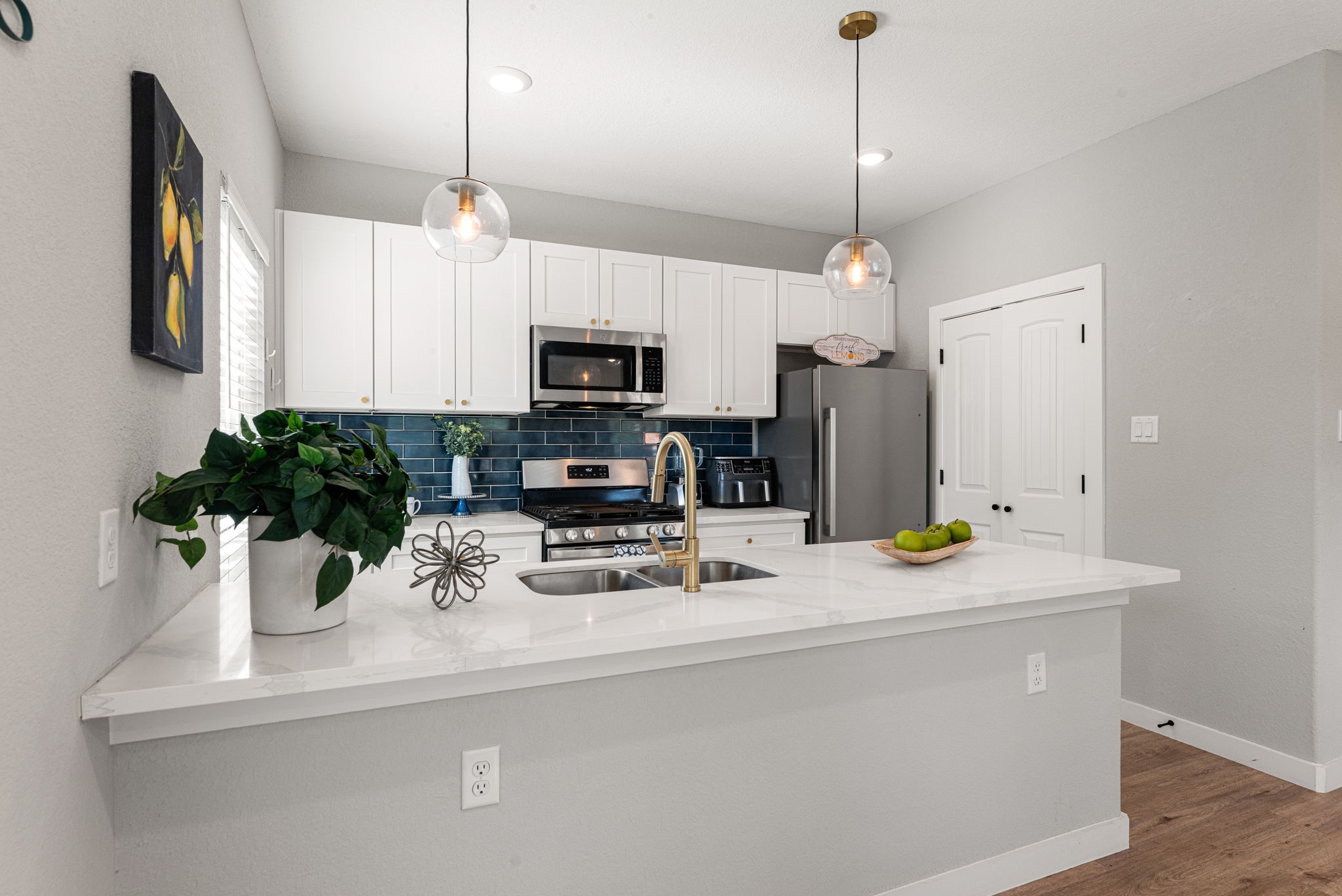 8357 Tate Street Houston, TX 77028 - Photo 15 of 42 a kitchen with a sink a counter space cabinets and appliances