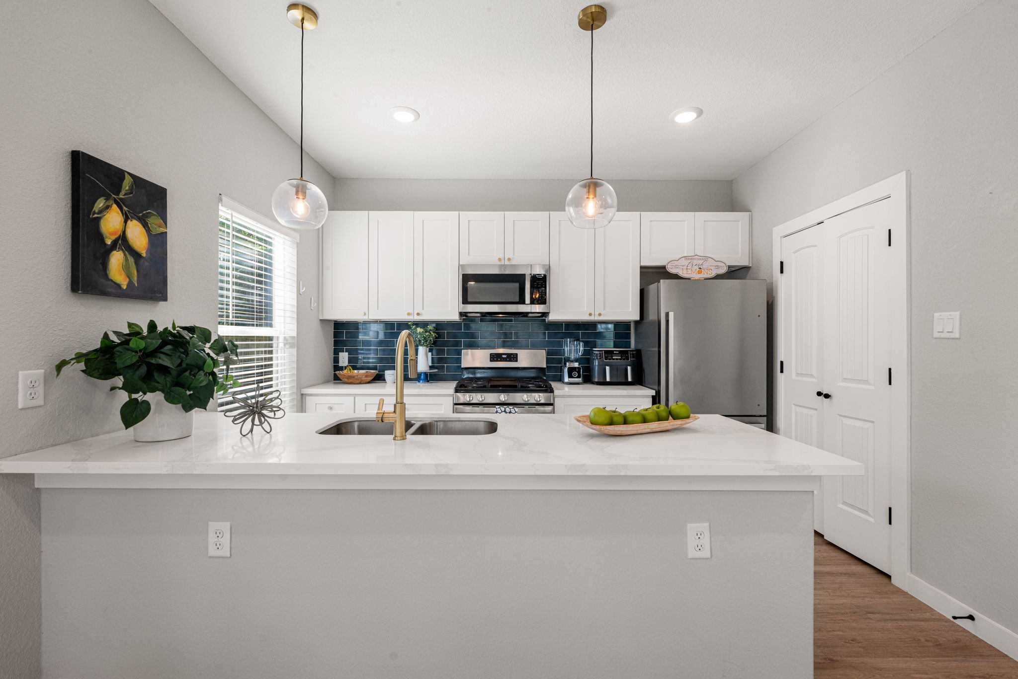 8357 Tate Street Houston, TX 77028 - Photo 16 of 42 a kitchen with a refrigerator a stove and a sink with wooden floor