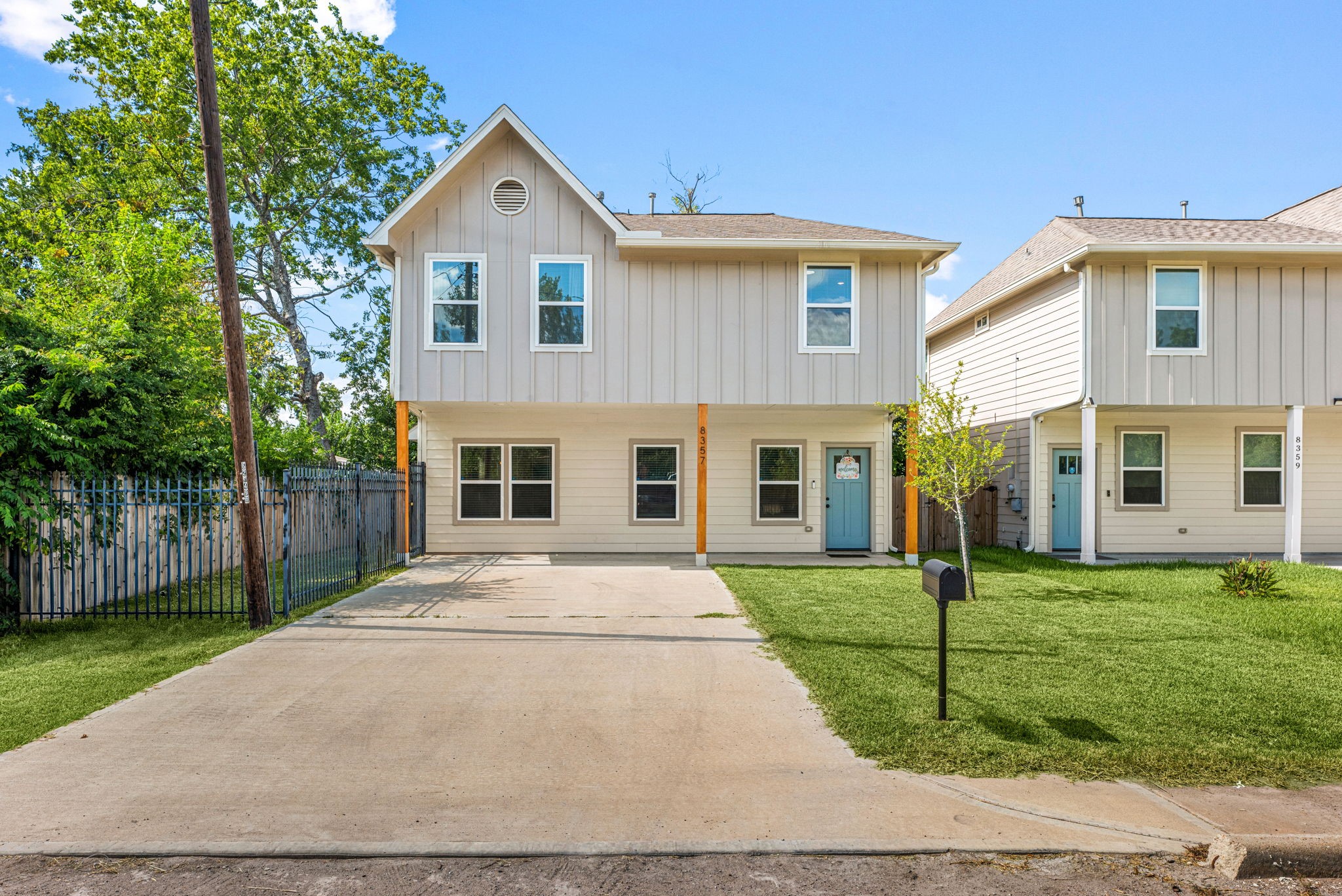 8357 Tate Street Houston, TX 77028 - Photo 2 of 42 a front view of a house with a yard and trees