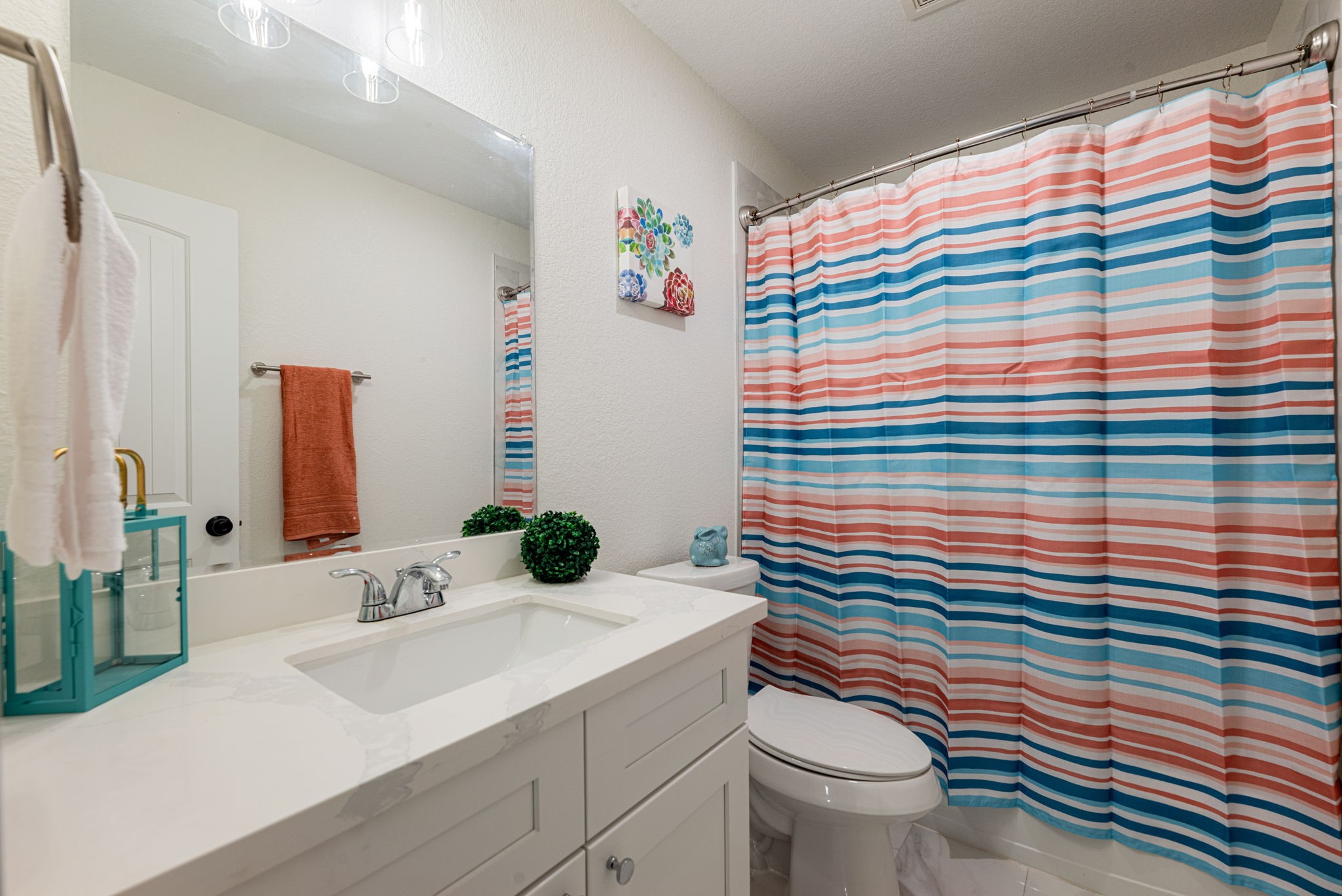 8357 Tate Street Houston, TX 77028 - Photo 23 of 42 a bathroom with a sink a toilet and shower curtain