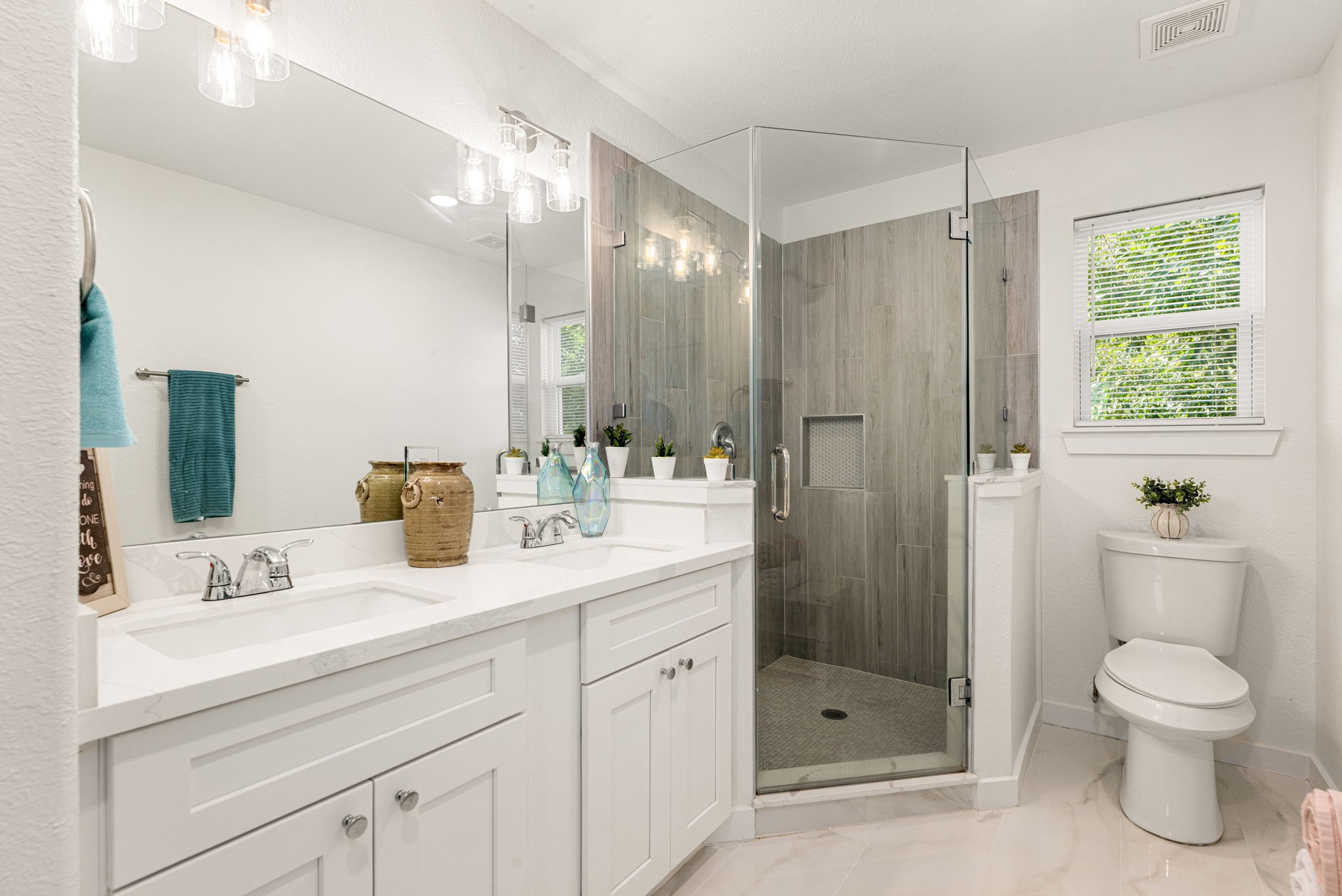 8357 Tate Street Houston, TX 77028 - Photo 26 of 42 a bathroom with a toilet a sink a shower and a mirror