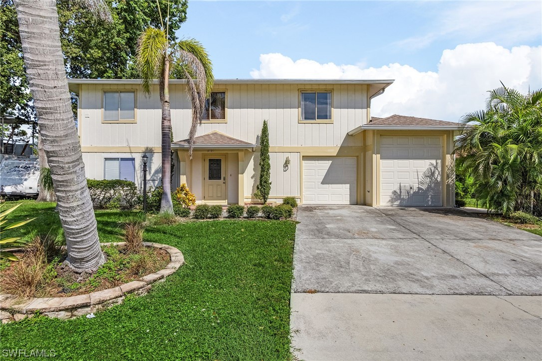 8185 Egret Road Fort Myers, FL 33967 - Photo 1 of 35 a view of a white house with a yard and potted plants