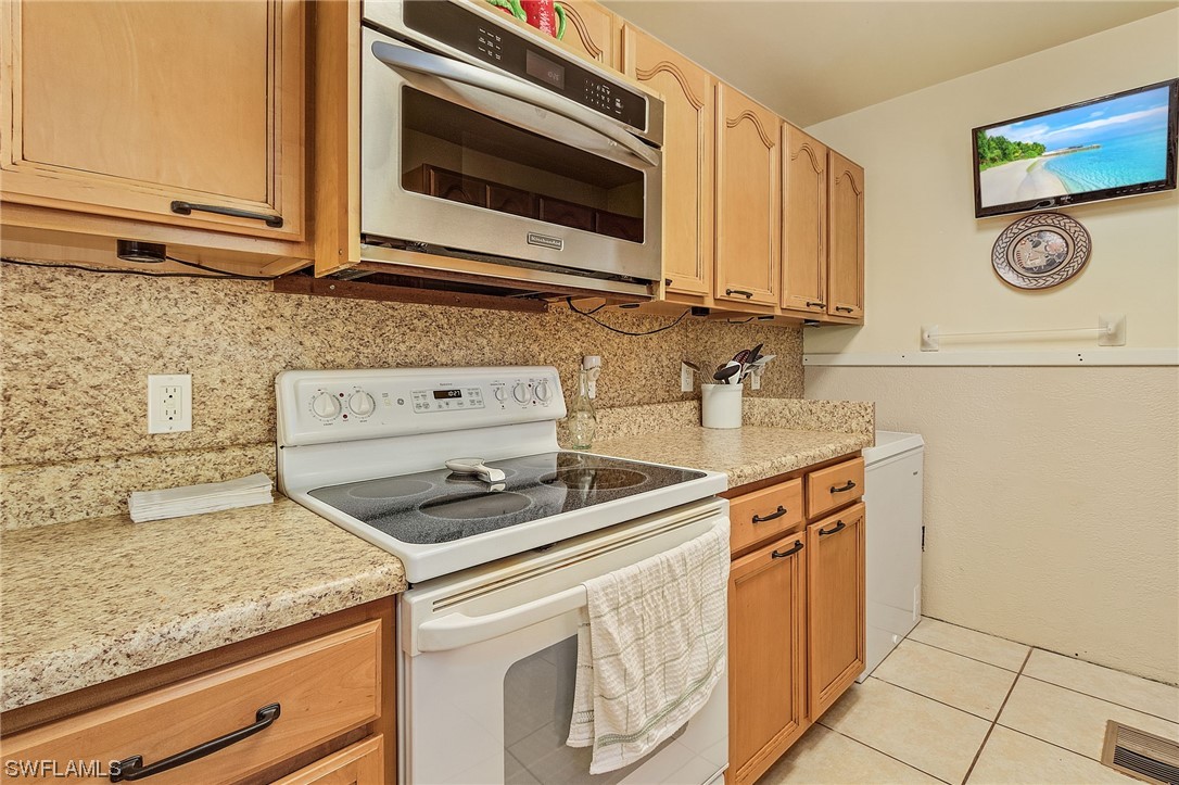 8185 Egret Road Fort Myers, FL 33967 - Photo 16 of 35 a kitchen with granite countertop cabinets stainless steel appliances and a counter space