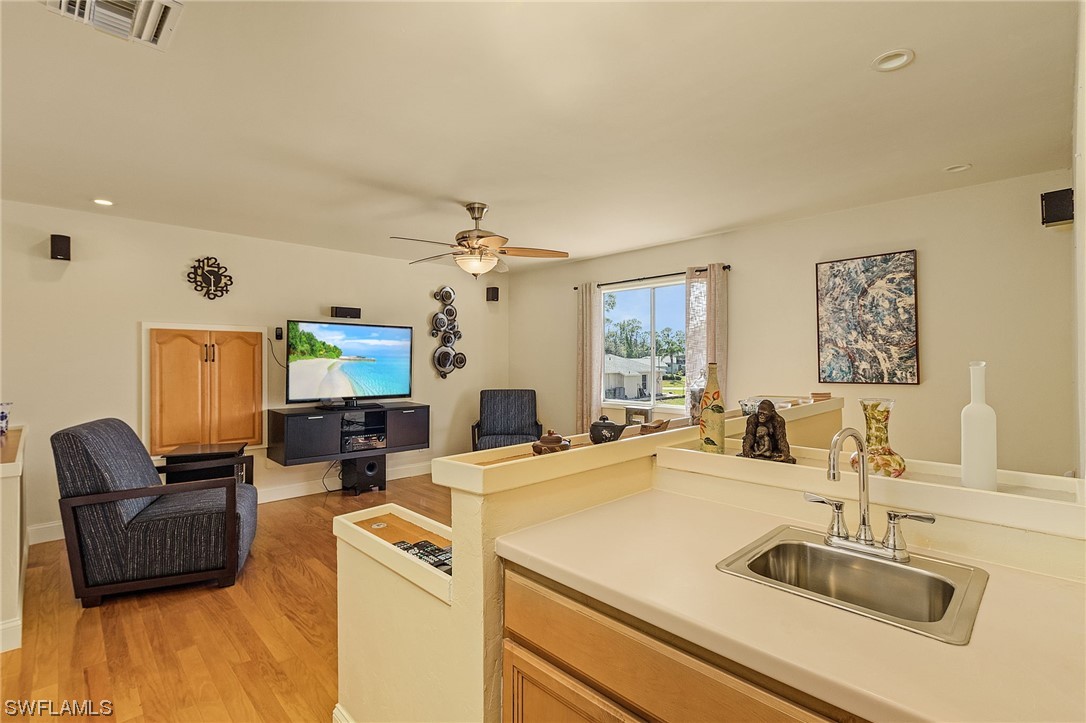 8185 Egret Road Fort Myers, FL 33967 - Photo 19 of 35 a living room with furniture and a flat screen tv