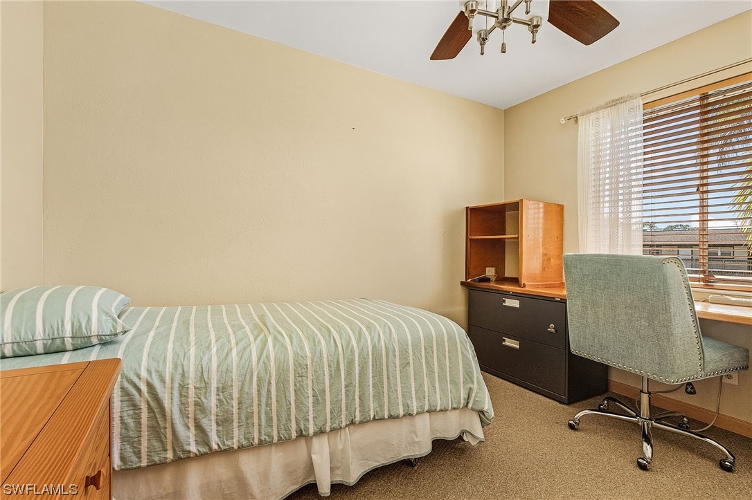8185 Egret Road Fort Myers, FL 33967 - Photo 26 of 35 a bedroom with a bed and a desk