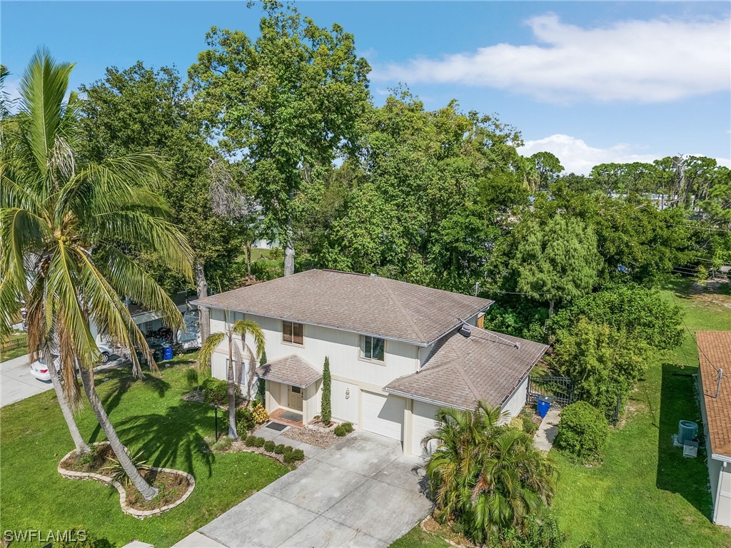 8185 Egret Road Fort Myers, FL 33967 - Photo 29 of 35 an aerial view of a house with garden space and trees