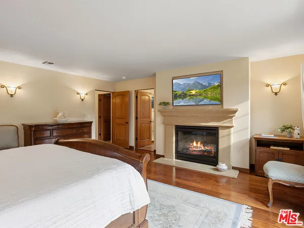 a bedroom with a bed and a fireplace
