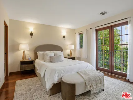 a bedroom with a large bed and a large window