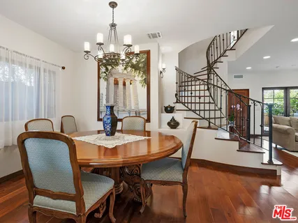 a view of a dining room with furniture wooden floor and chandelier