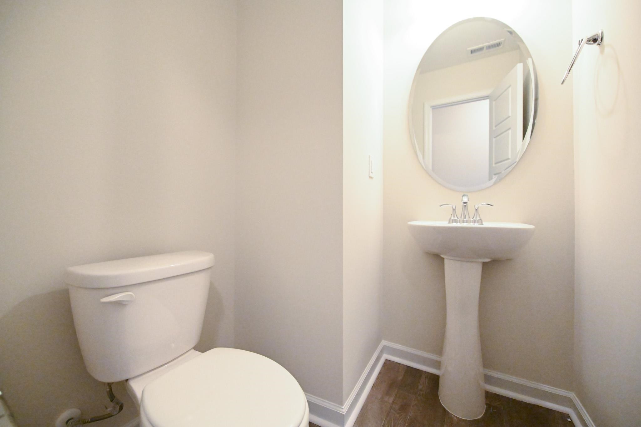 1701 Ramsdale Road Hope Mills, NC 28348 - Photo 12 of 25 a white toilet sitting next to a bathroom sink
