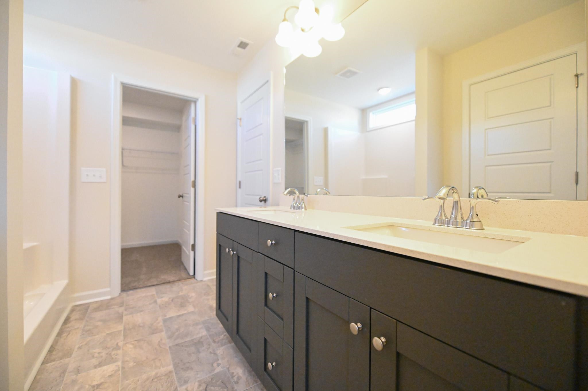 1701 Ramsdale Road Hope Mills, NC 28348 - Photo 18 of 25 a bathroom with a double vanity sink mirror and double