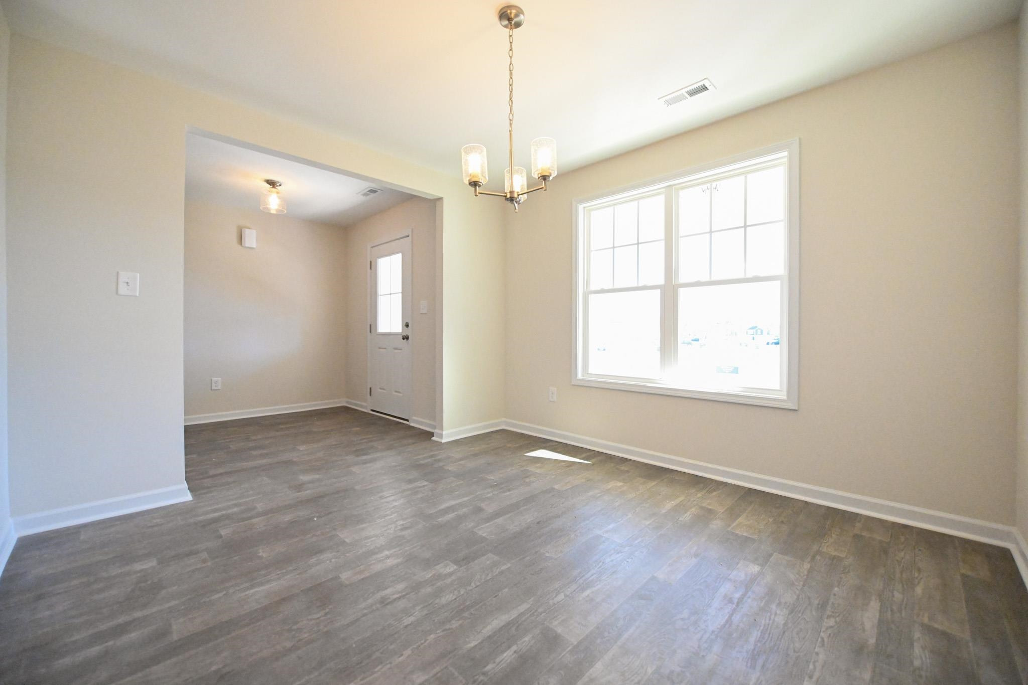 1701 Ramsdale Road Hope Mills, NC 28348 - Photo 3 of 25 an empty room with wooden floor and windows