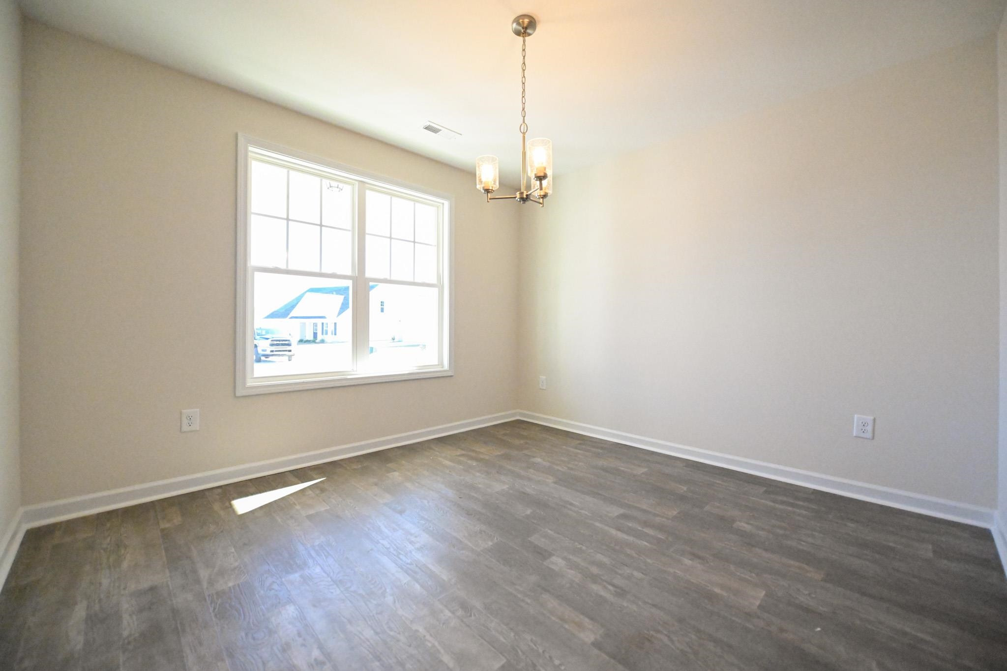 1701 Ramsdale Road Hope Mills, NC 28348 - Photo 4 of 25 an empty room with wooden floor and windows
