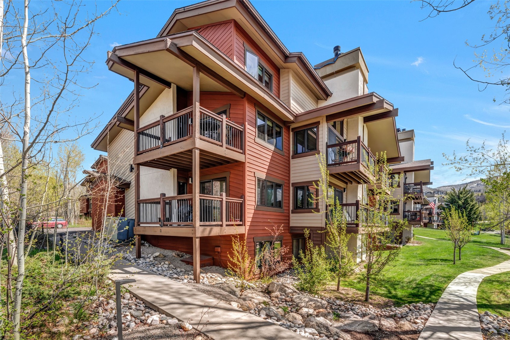 1675 Ranch Road, Unit 411 Steamboat Springs, CO 80487 - Photo 40 of 48 Rear view of house with a lawn and a balcony