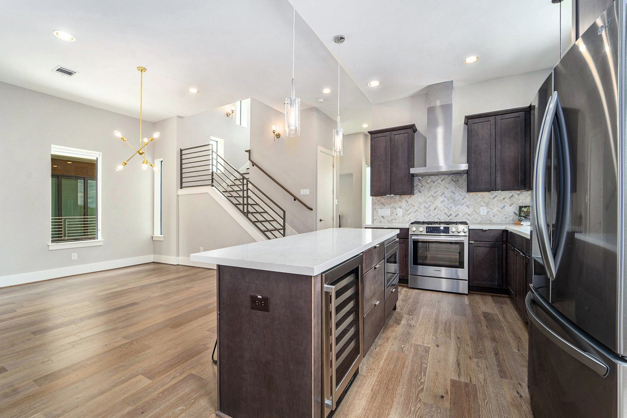 1507 Truxillo Street, Unit A Houston, TX 77004 - Photo 15 of 30 a kitchen with kitchen island stainless steel appliances a sink cabinets and wooden floor