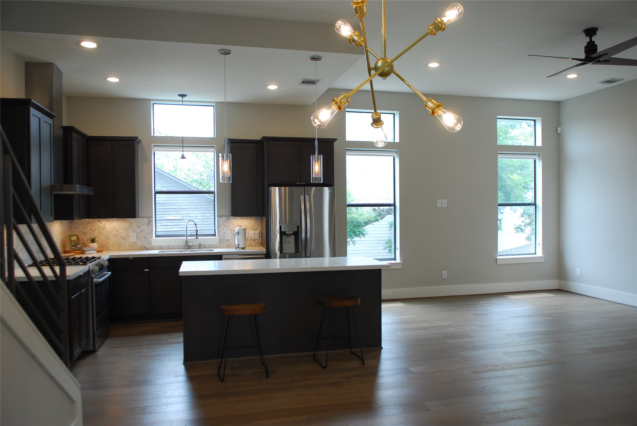 1507 Truxillo Street, Unit A Houston, TX 77004 - Photo 18 of 30 a kitchen with stainless steel appliances granite countertop a sink a stove a refrigerator cabinets and wooden floor