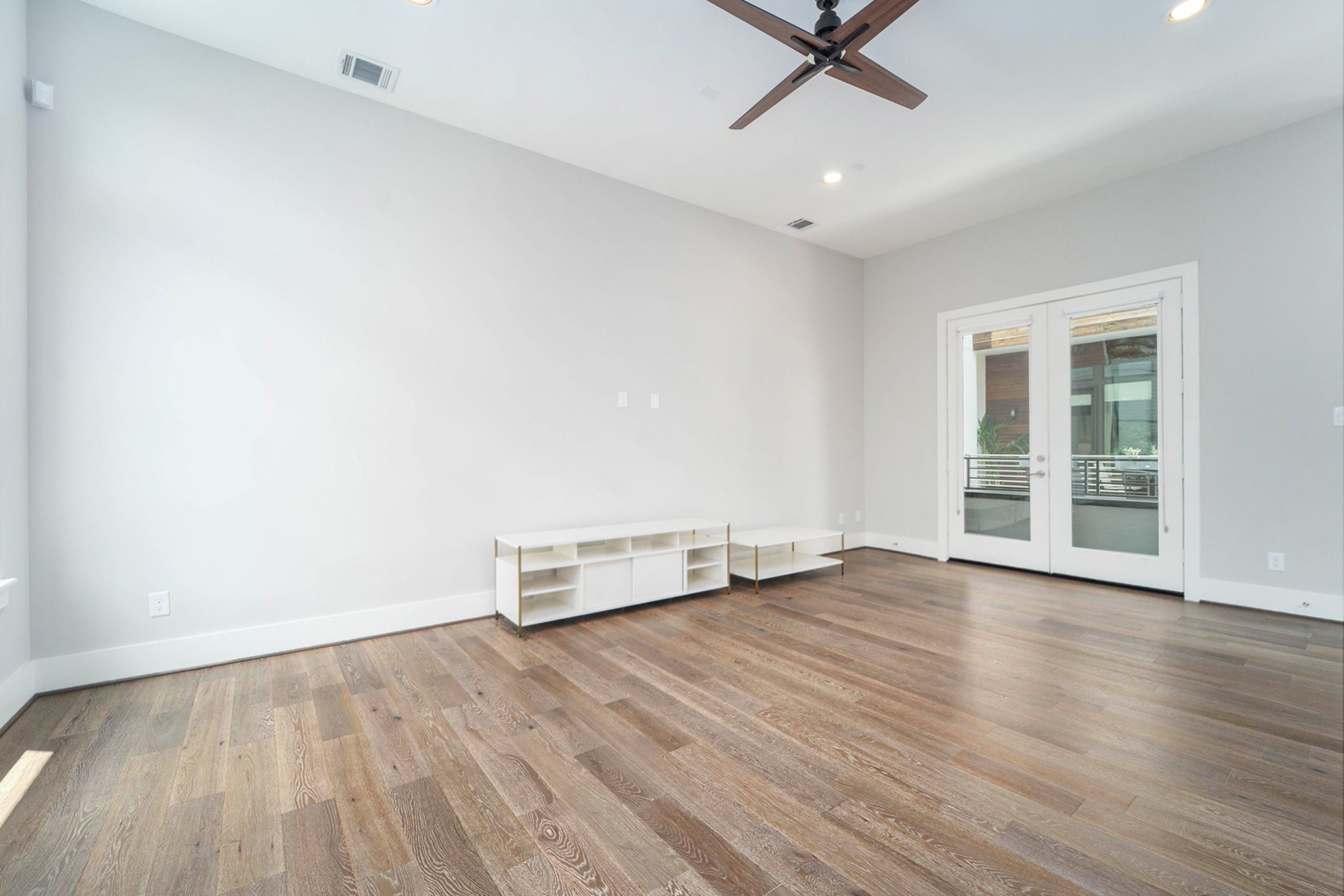 1507 Truxillo Street, Unit A Houston, TX 77004 - Photo 8 of 30 an empty room with wooden floor a ceiling fan and windows