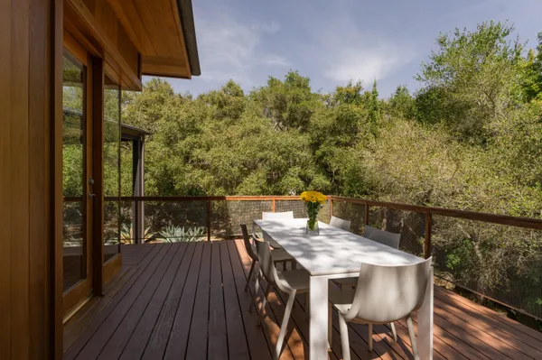 a view of a balcony with furniture and wooden floor