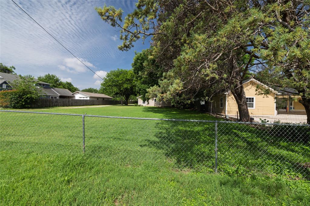 313 North Roe Street White Settlement, TX 76108 - Photo 31 of 33 Expansive green lawn providing ample outdoor space