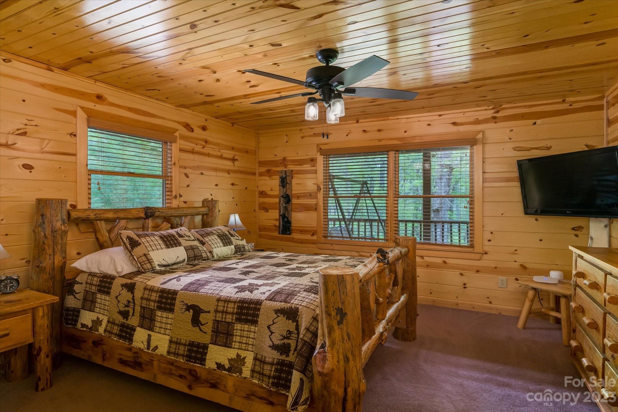 144 Camp David Road Murphy, NC 28906 - Photo 12 of 46 a bedroom with a bed next to a window with a flat screen tv