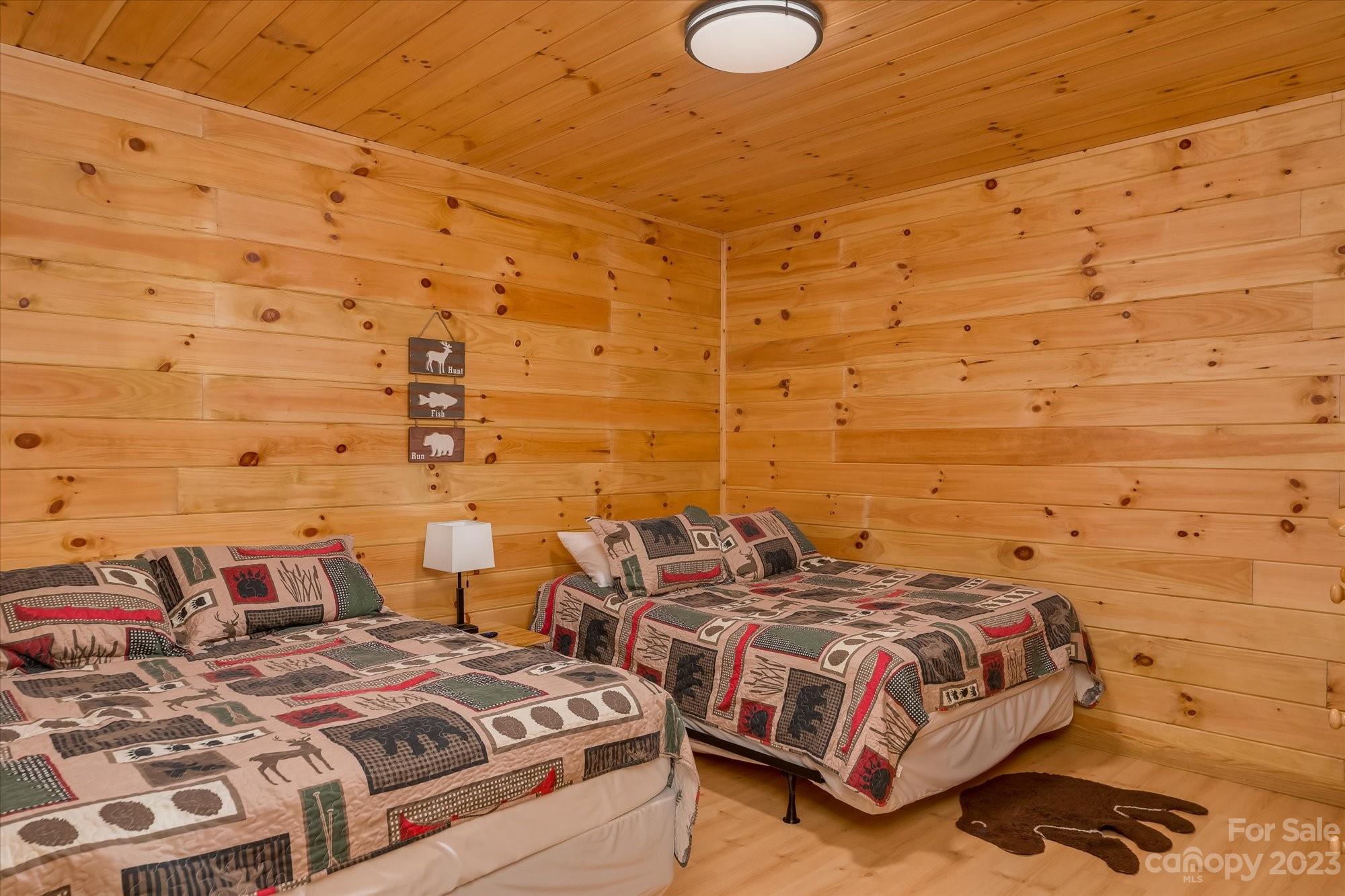 144 Camp David Road Murphy, NC 28906 - Photo 23 of 46 a bedroom with a bed and brick wall