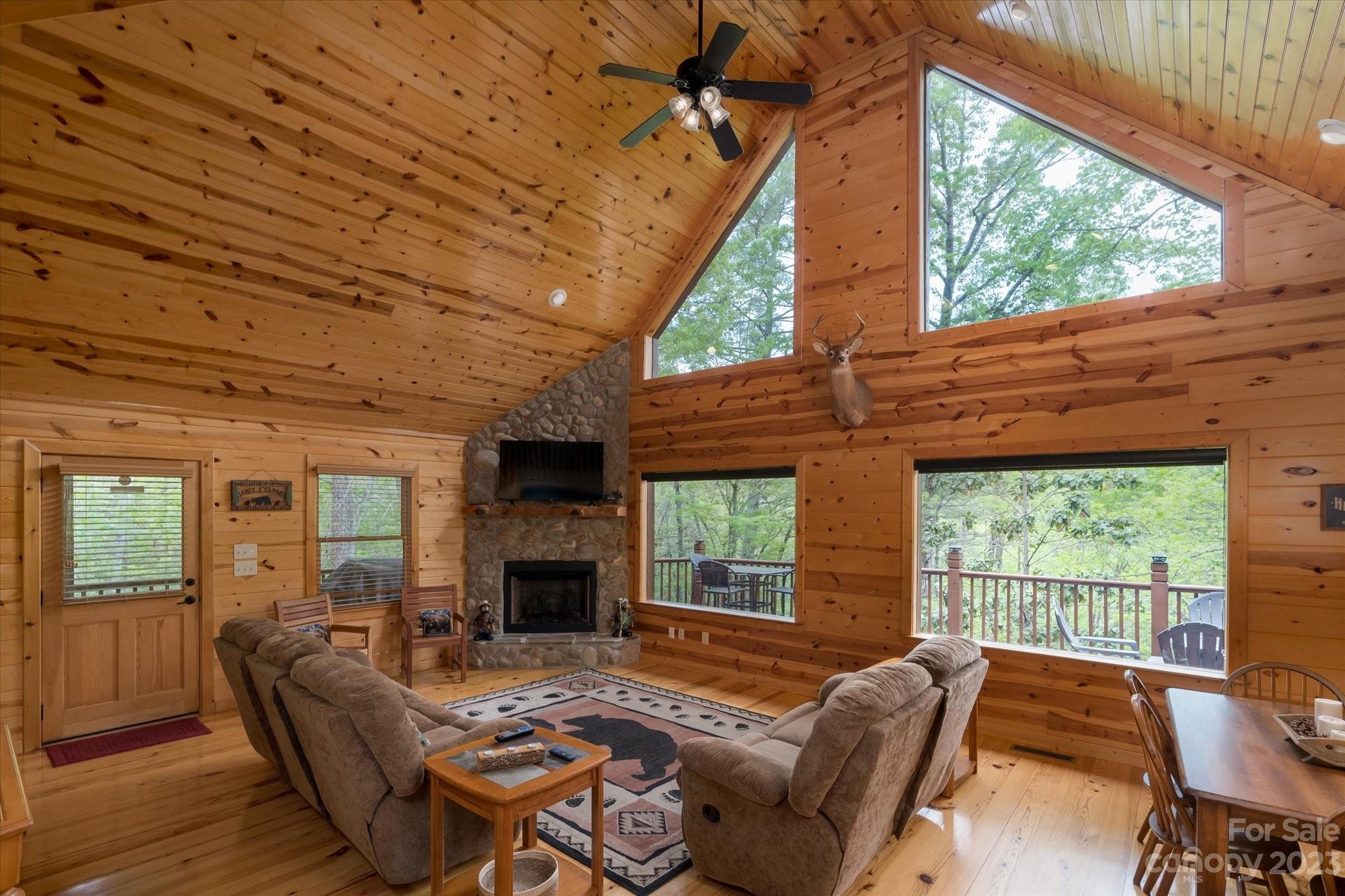 144 Camp David Road Murphy, NC 28906 - Photo 7 of 46 a living room with furniture a fireplace and a floor to ceiling window