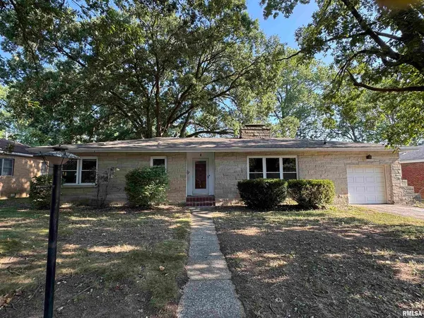 a view of a house with a yard and large tree