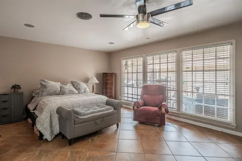 a bedroom with a bed and glass window