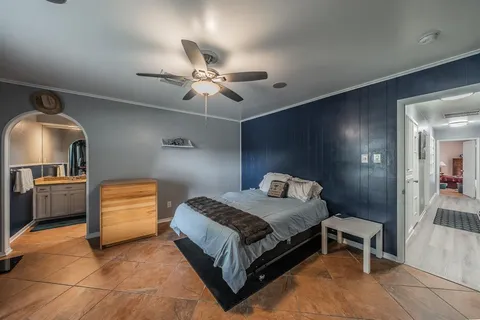 a bedroom with a bed and a chandelier
