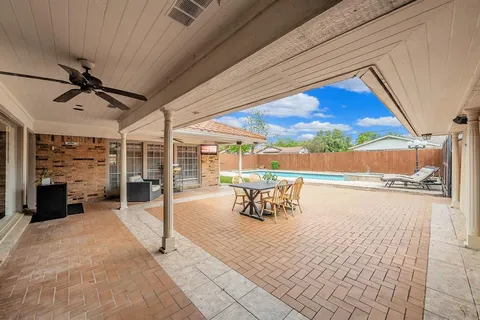 a view of a patio with a table and chairs