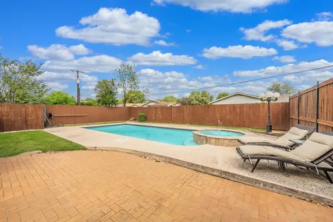 a backyard of a house with table and chairs