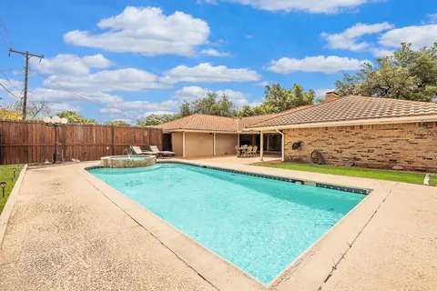a view of a house with a backyard
