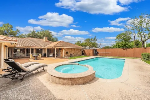 a swimming pool with outdoor seating yard and barbeque oven