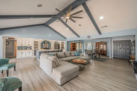 a living room with furniture and wooden floor