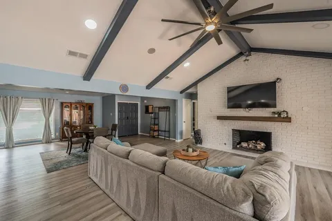 a living room with furniture and a fireplace