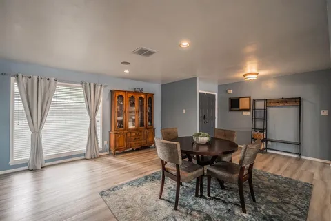 a view of a dining room with furniture and window