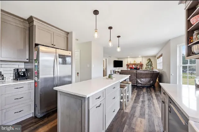a kitchen with a sink appliances and cabinets