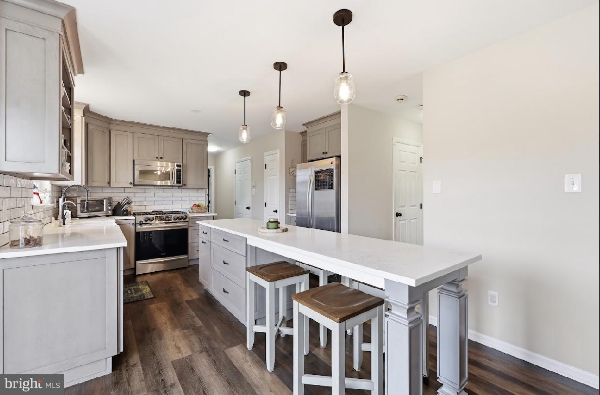 119 Basin Road Hammonton, NJ 08037 - Photo 12 of 29 a kitchen with a sink a stove and chairs