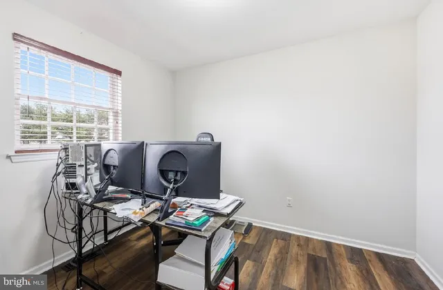 a view of workspace with furniture and window