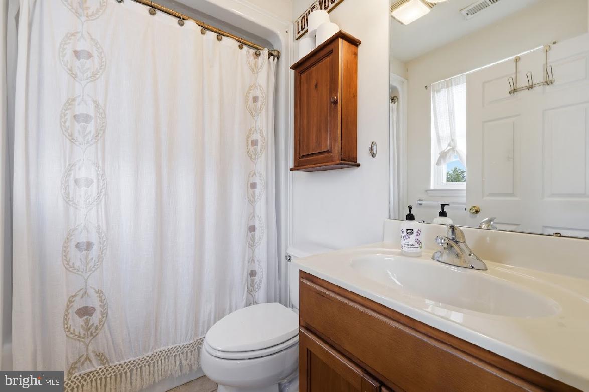 119 Basin Road Hammonton, NJ 08037 - Photo 20 of 29 a bathroom with a sink a toilet and a mirror