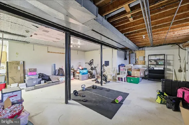 a living room with lots of furniture and baby bed
