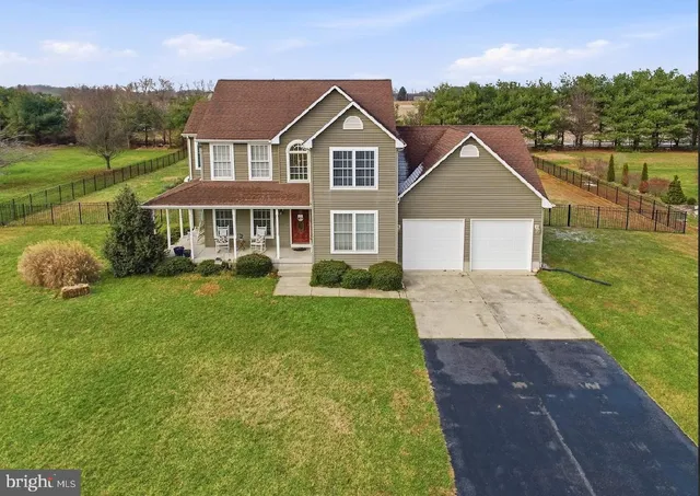 a view of a house with a yard and a lake view