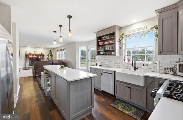 a kitchen with kitchen island a sink stove and refrigerator