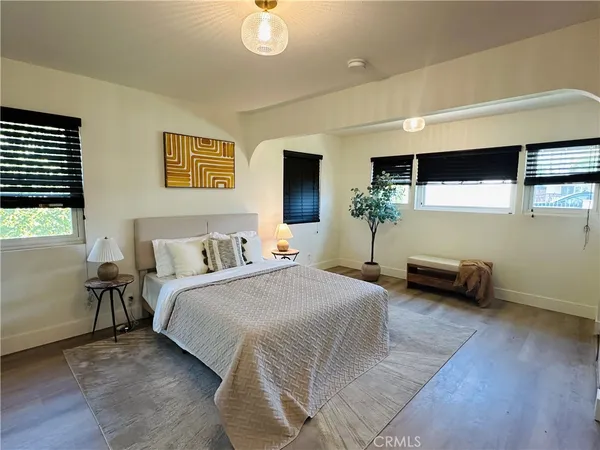 a bedroom with bed and a large window