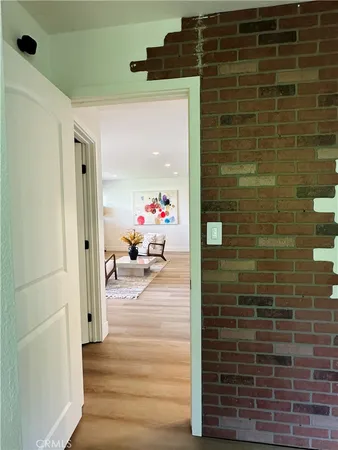 a hallway with a door and a mirror