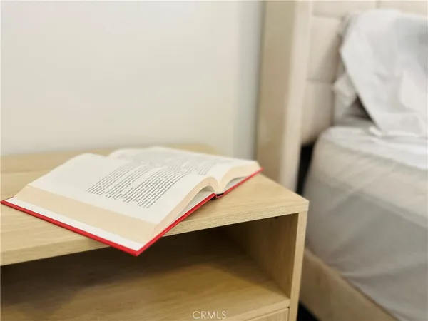 a bedroom with a bed and a night stand