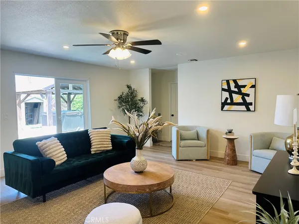 a living room with furniture and a potted plant