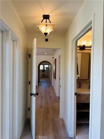 a view of a hallway view with wooden floor and staircase