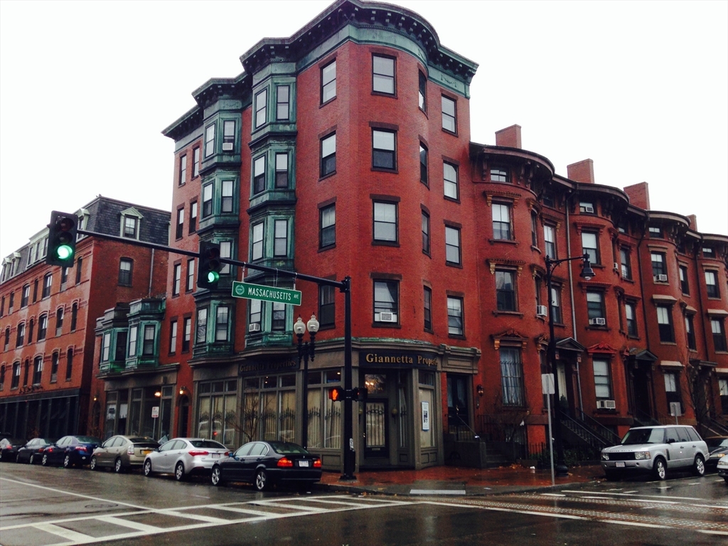 585 Massachusetts Avenue, Unit A Boston, MA 02118 - Photo 1 of 8 a front view of a building with lot of cars and trees